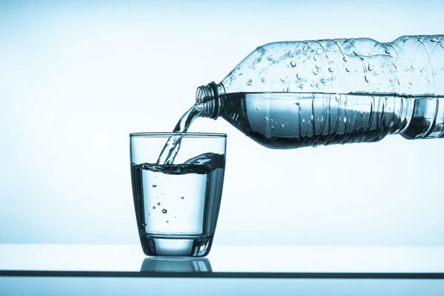 Picture of a bottle of water pouring into a glass.