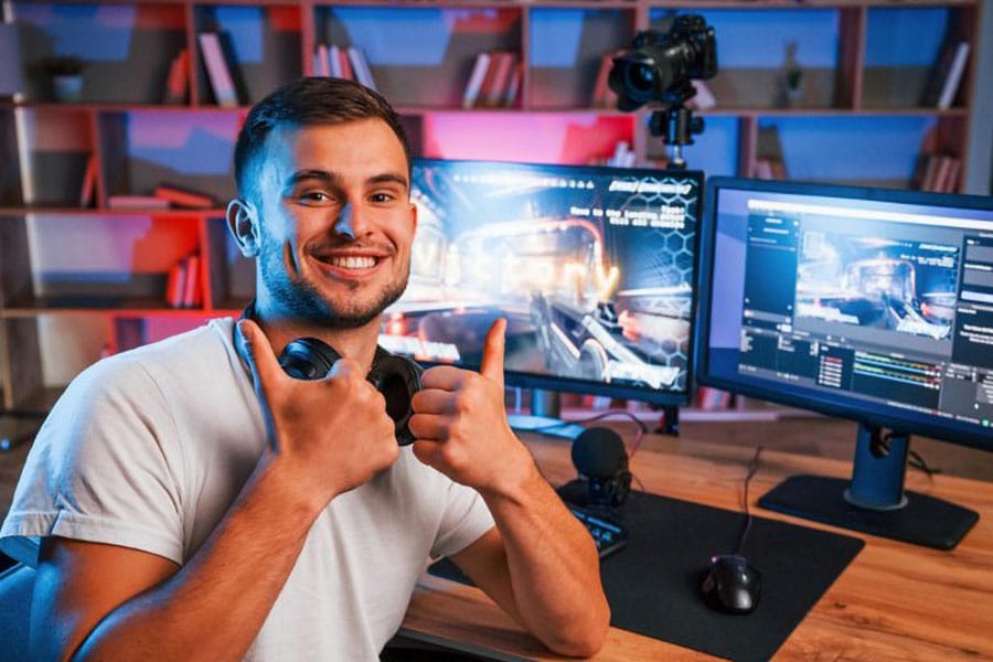 Picture of a Streamer with his setup being happy about making money via twitch.