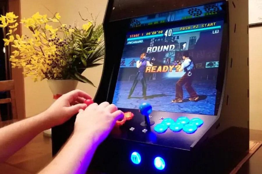 Picture of a gamer playing with a DIY Arcade Kit, a birthday gift for video gamer.