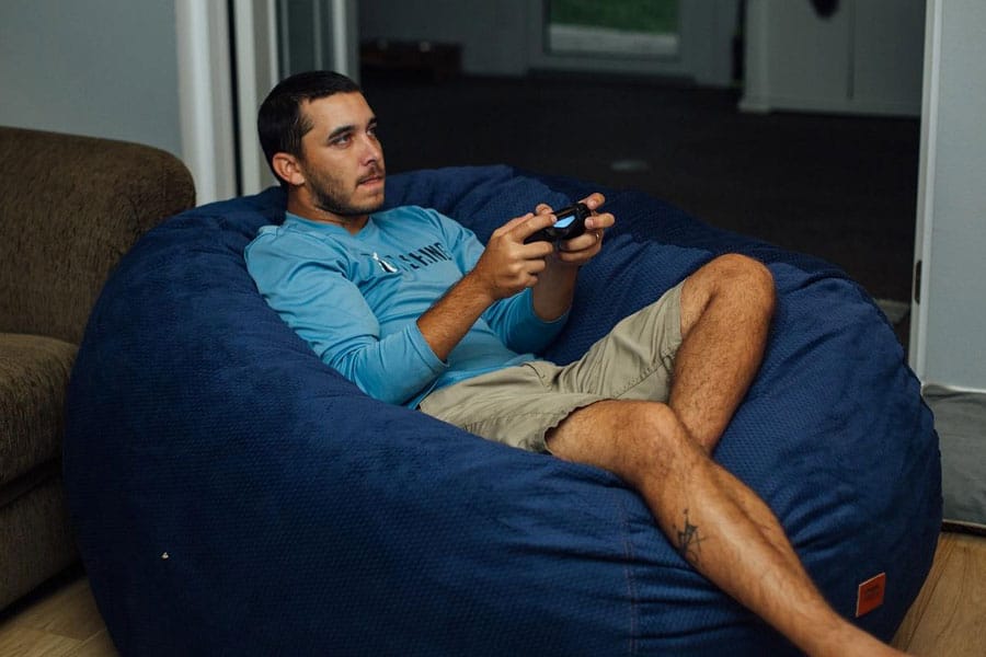 Picture of a gamer on a Gaming Bean Bag Chair, a birthday gift for video gamer.