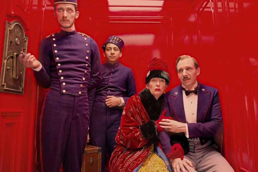 a picture of The Grand Budapest Hotel with its characters, one of comedy movies for gamers.