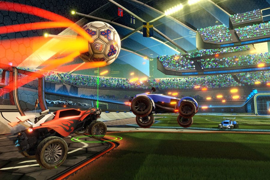 Cars playing soccer in Rocket League on a TV screen.