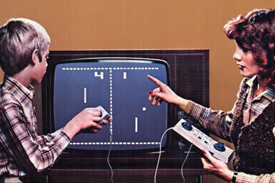 Picture of a Mother and a child Playing Pong, one of most influential video games of all time.