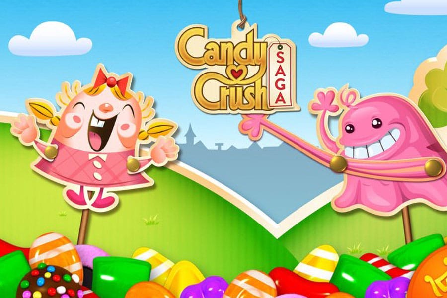 A poster of the game Candy Crush Saga made by KING, showing various candies, a happy girl and a ghost.