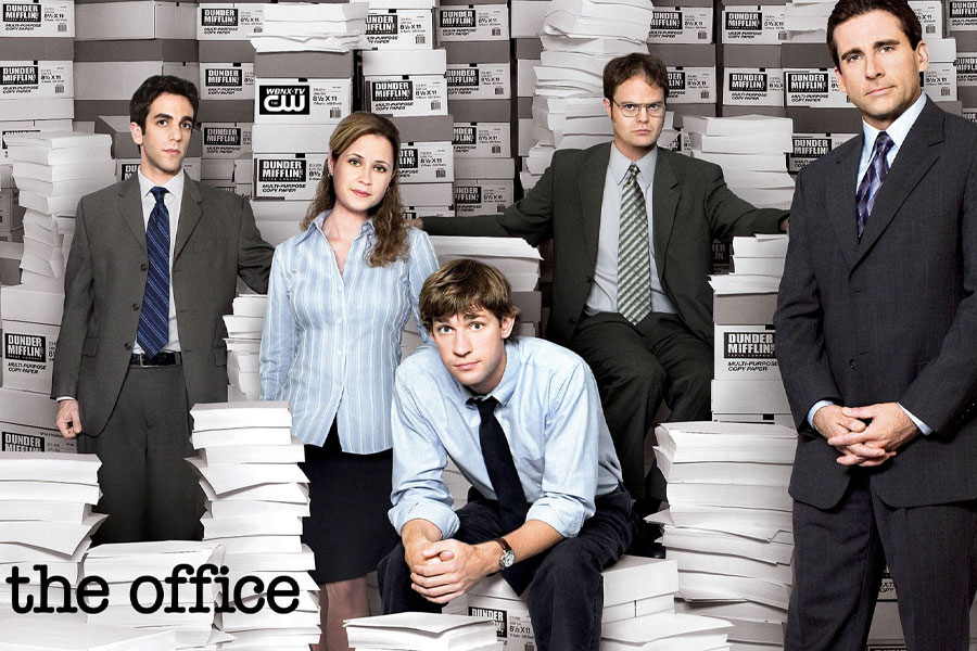 Characters from The Office (US) sitting in a conference room.