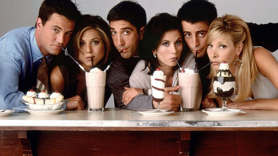 The main cast of Friends sitting on a couch.