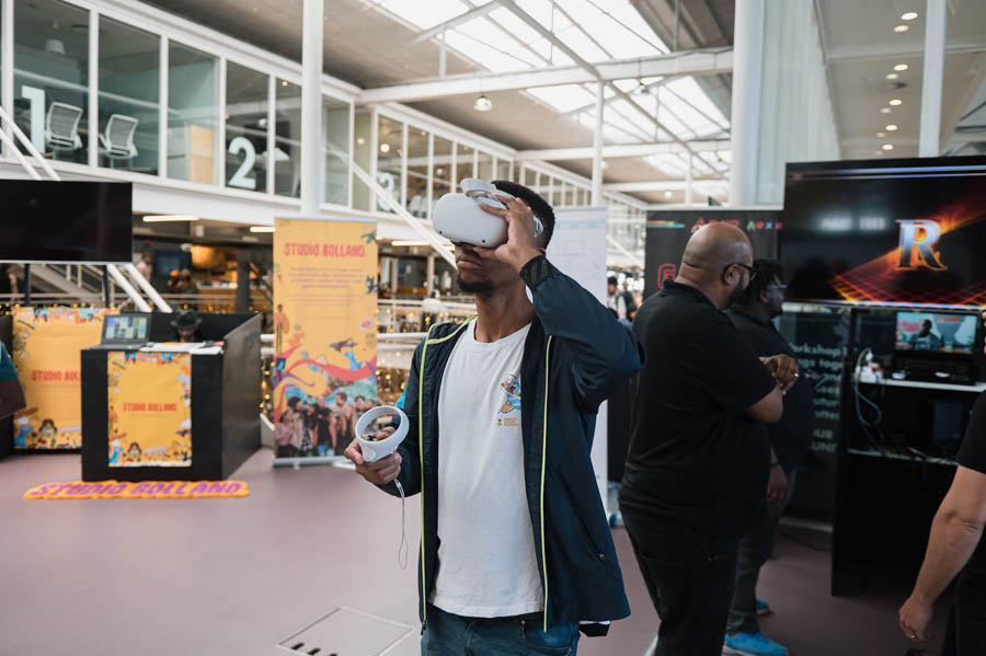 a black person working with VR in a hall.