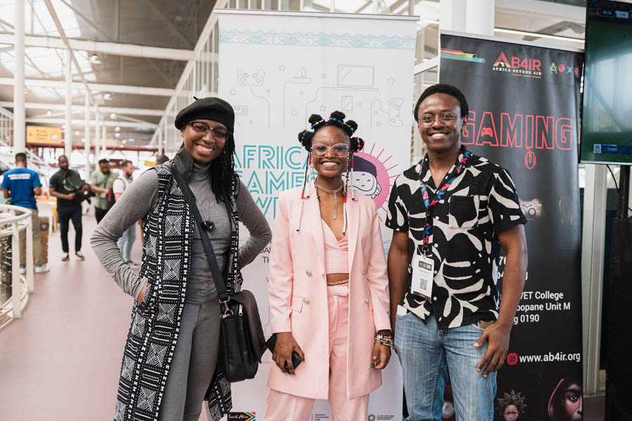 three exited black people taking picture in Africa Games Week 2024.